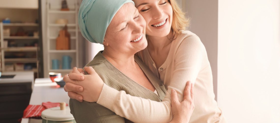 Young woman visiting her mother with cancer indoors